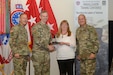 Three Soldiers present award to one civilian