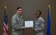 Spring CCAF graduates receive diplomas during ceremony with 932nd Airlift Wing commander, Col. Raymond Smith.