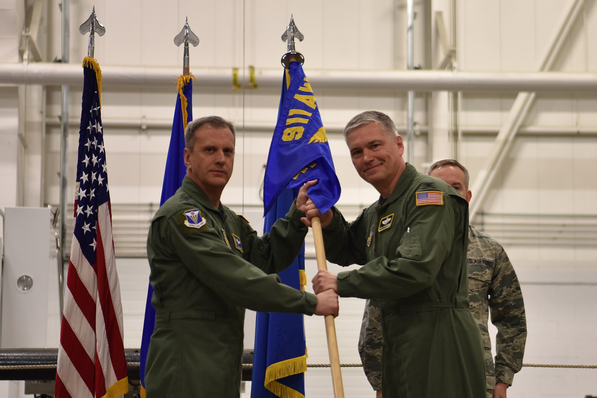 Maj. Gen. Randall A. Ogden, 4th Air Force commander, gives the guidon to 911th Airlift Wing Commander Col. Douglas N. Strawbridge during an assumption of command ceremony at the Pittsburgh International Airport Air Reserve Station, Pennsylvania, April 6, 2018. Strawbridge will lead the wing through a period of change as it converts its mission capabilities from the C-130 Hercules aircraft to the C-17 Globemaster III. (U.S. Air Force photo by Staff Sgt. Marjorie A. Bowlden)