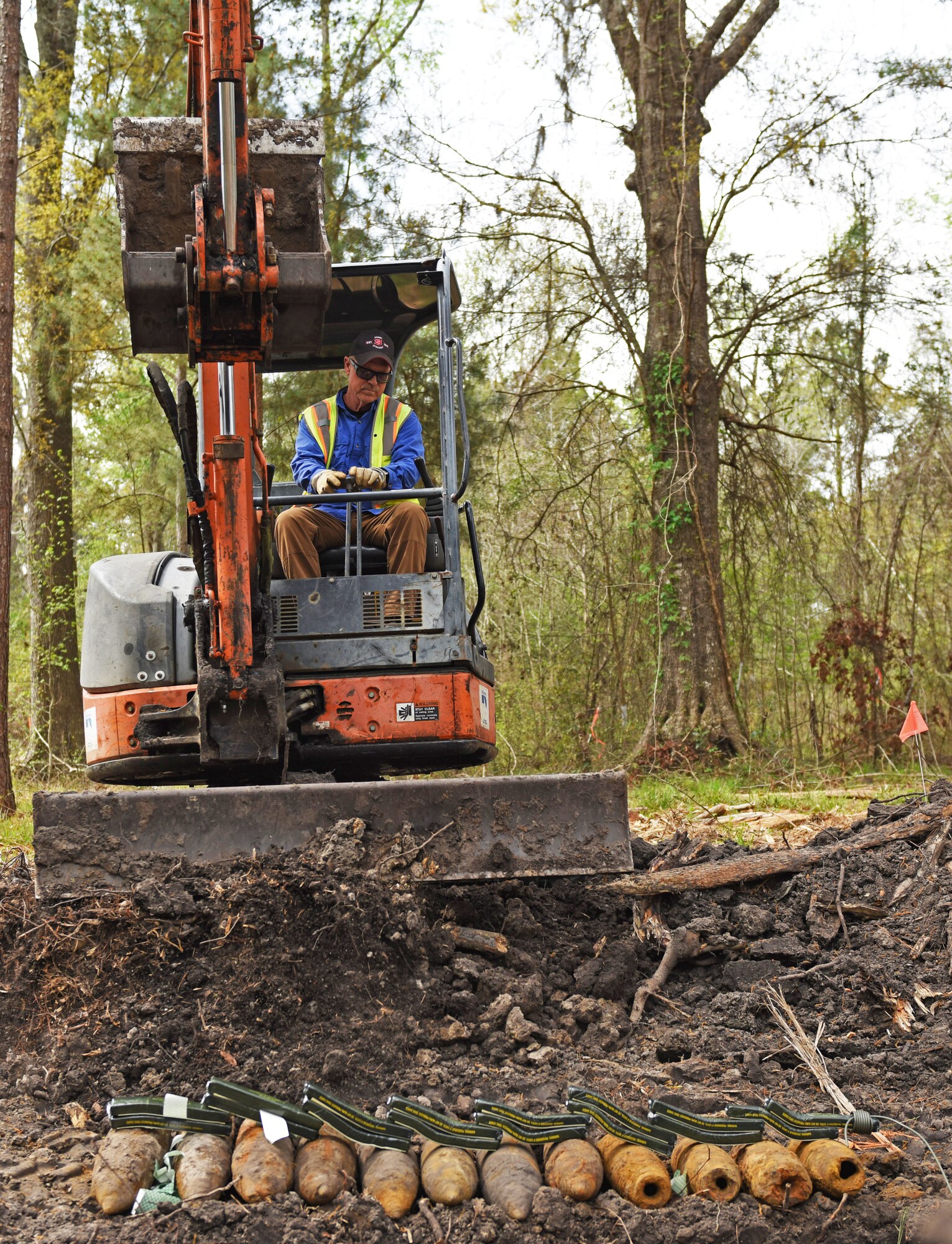 Former explosive ordnance disposal member puts dirt on top of C4 and unexploded ordinance in Conway, S.C., April 4.