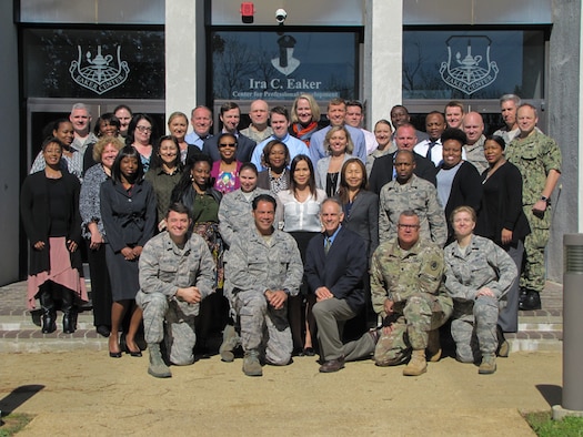Lt. Col. David J. Ratliff, Ira C. Eaker Center for Professional Development instructor, (front row, far left) joins co-workers for a group photo. The Eaker Center is composed of four primary schools: Commanders' Professional Development School, U.S. Air Force Chaplain Corps College, Defense Financial Management and Comptroller School, and the AF Personnel Professional Development School. (Courtesy photo)