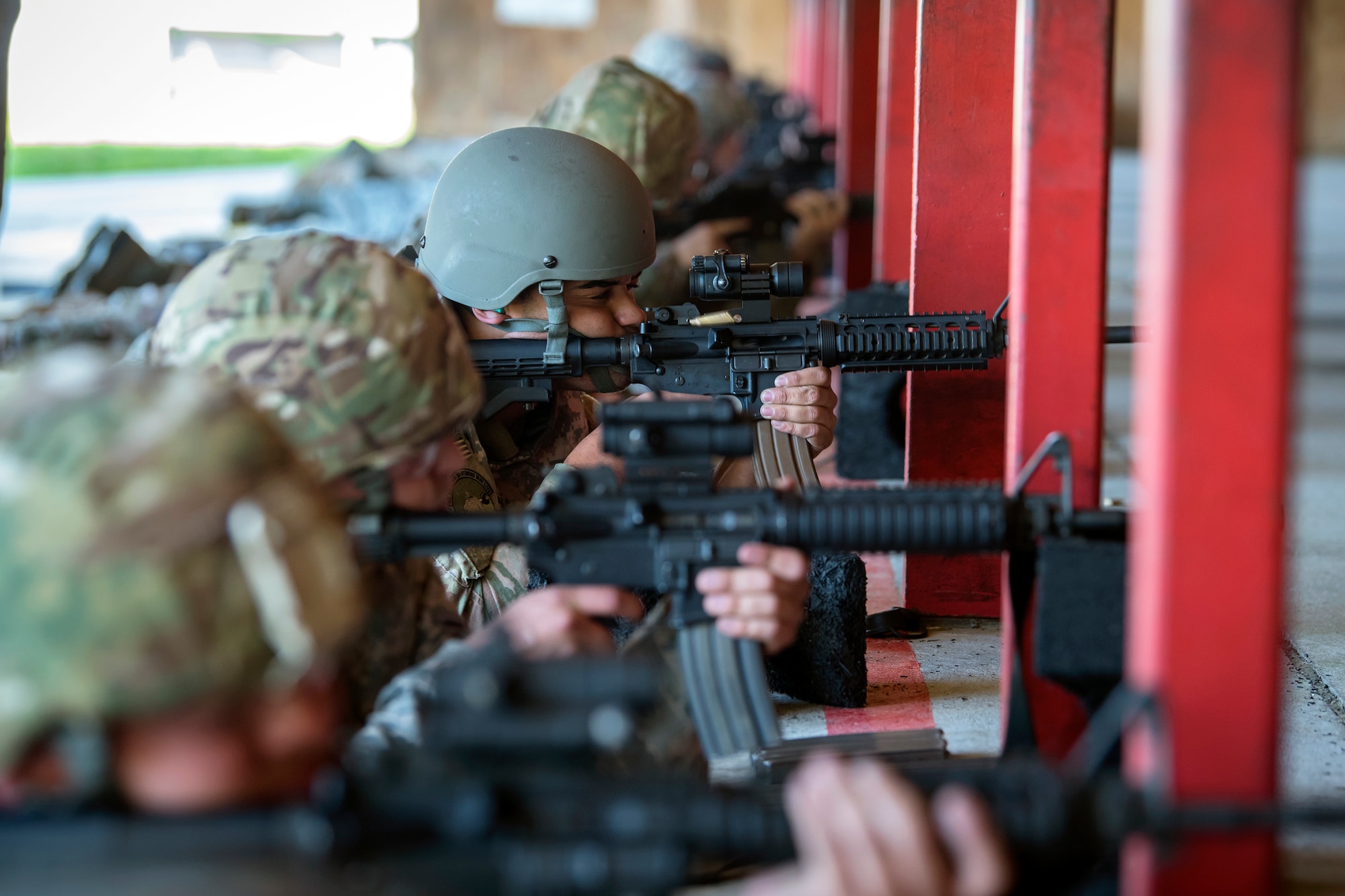 Students look down their sights as they fire M4 carbines during a Combat Arms Training and Maintenance (CATM) class, April 3, 2018, at Moody Air Force Base, Ga. Airmen must demonstrate quality safety standards while handling and shooting their weapons proficiently in order to be eligible to deploy. Throughout the class the instructors emphasized: weapon handling techniques, proper sight usage and internal weapon cleaning procedures. (U.S. Air Force photo by Airman Eugene Oliver)