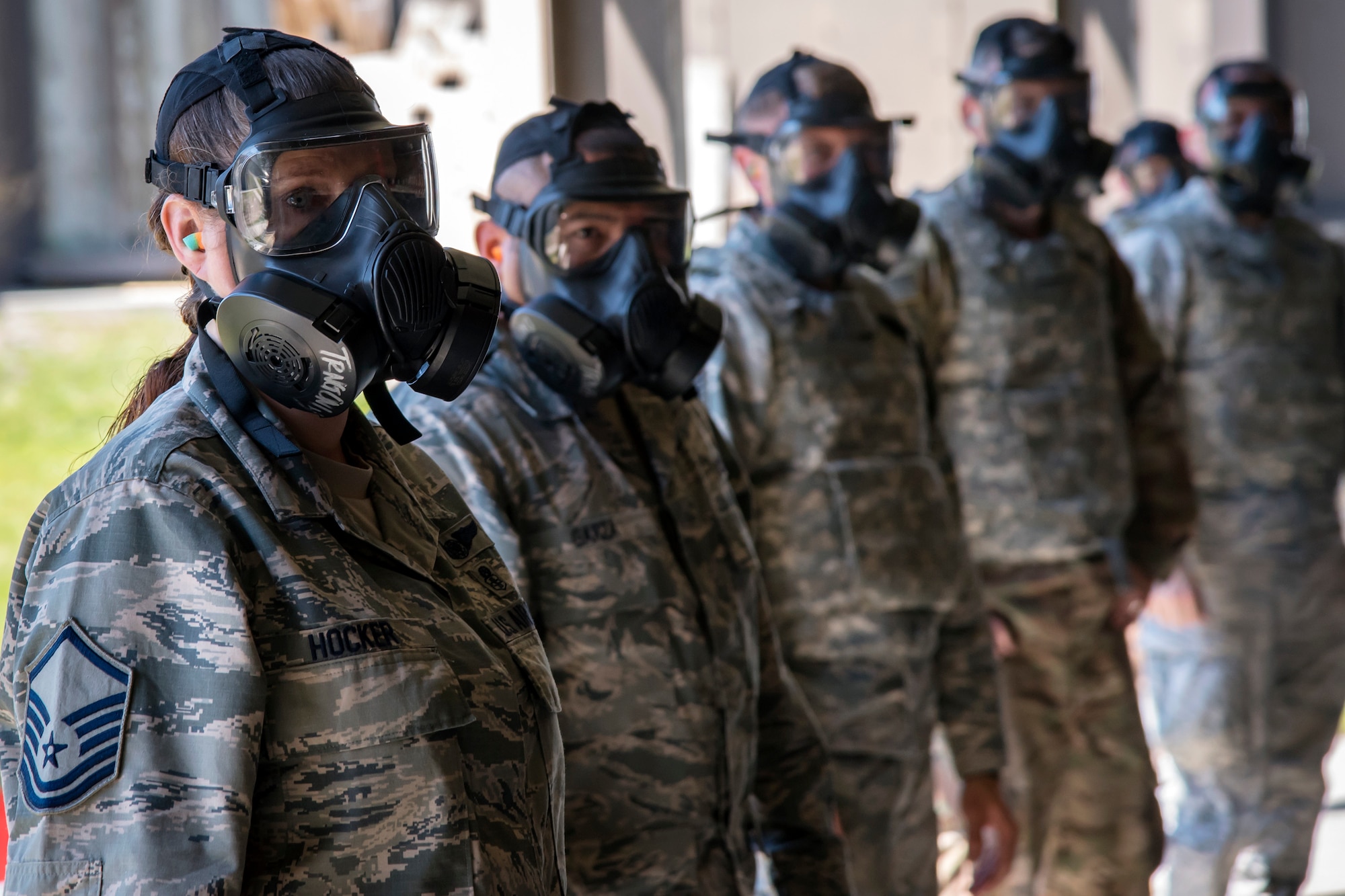 Students listen to instruction while wearing gas masks during a Combat Arms Training and Maintenance (CATM) class, April 3, 2018, at Moody Air Force Base, Ga. Airmen must demonstrate quality safety standards while handling and shooting their weapons proficiently in order to be eligible to deploy. Throughout the class the instructors emphasized: weapon handling techniques, proper sight usage and internal weapon cleaning procedures. (U.S. Air Force photo by Airman Eugene Oliver)