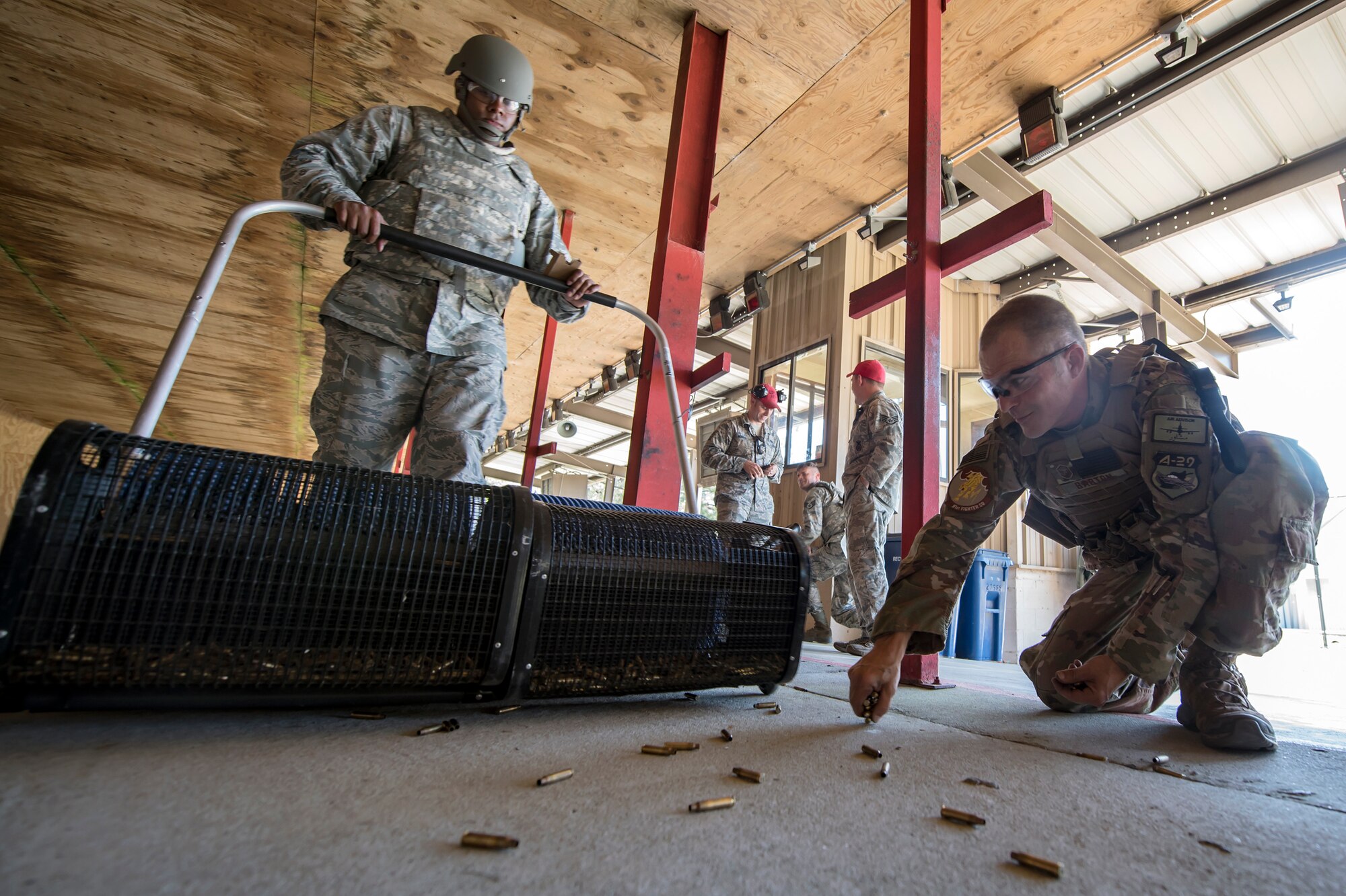 Tech. Sgt. Jonathon Tyler, left, 23d Maintenance Group munitions specialist, collects bullet casings with a brass roller following a Combat Arms Training and Maintenance (CATM) class, April 3, 2018, at Moody Air Force Base, Ga. Airmen must demonstrate quality safety standards while handling and shooting their weapons proficiently in order to be eligible to deploy. Throughout the class the instructors emphasized: weapon handling techniques, proper sight usage and internal weapon cleaning procedures.   (U.S. Air Force photo by Airman Eugene Oliver)