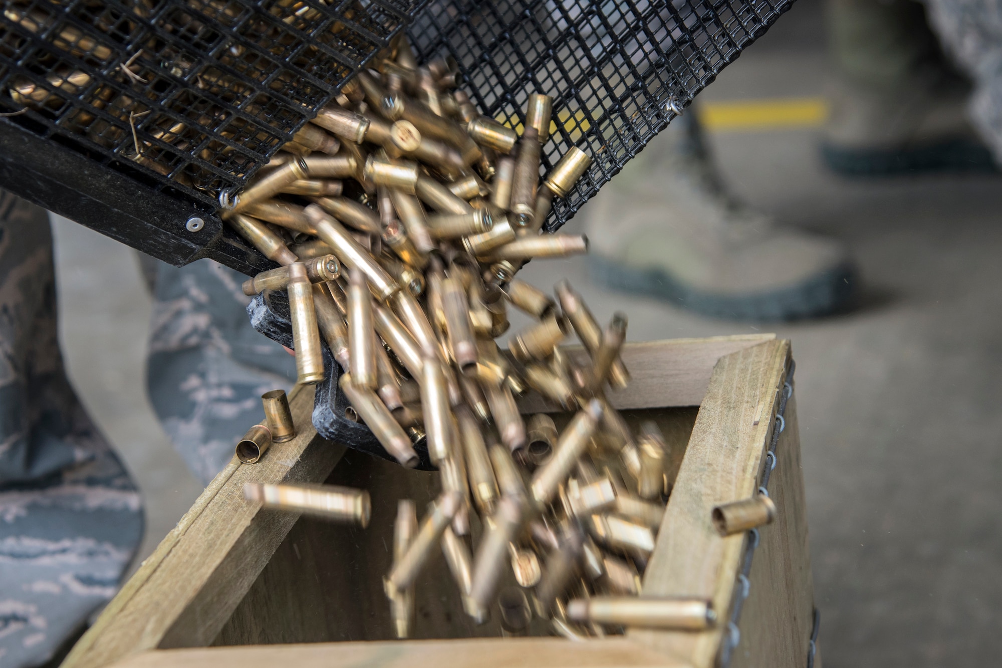 Bullet casings fall into a wooden box following a Combat Arms Training and Maintenance (CATM) class, April 4, 2018, at Moody Air Force Base, Ga. Airmen must demonstrate quality safety standards while handling and shooting their weapons proficiently in order to be eligible to deploy. Throughout the class the instructors emphasized: weapon handling techniques, proper sight usage and internal weapon cleaning procedures. (U.S. Air Force photo by Airman Eugene Oliver)