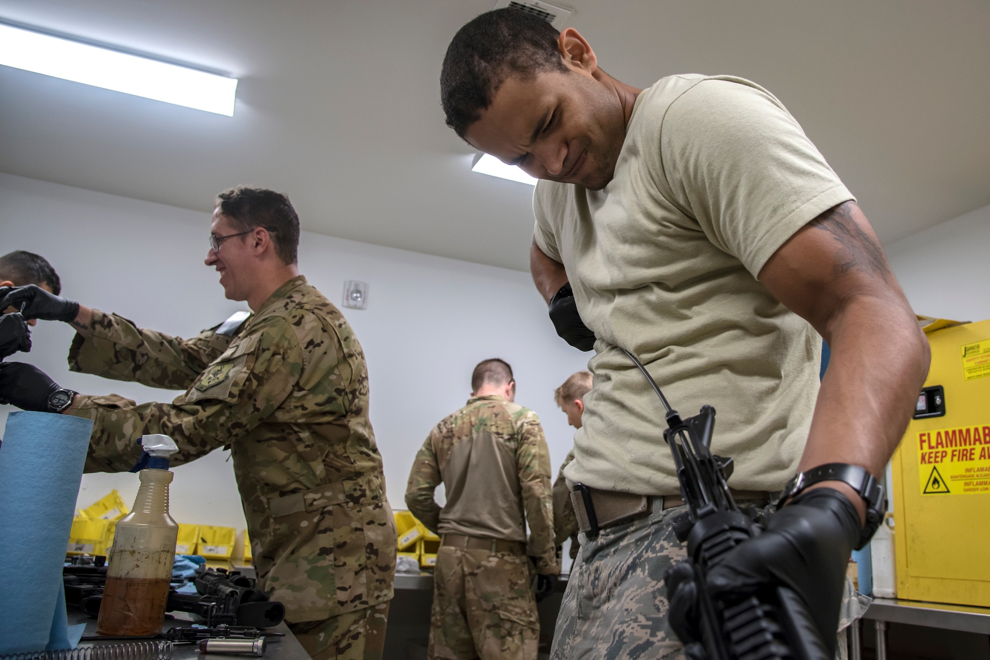 Staff Sgt. Dylan Wren, right, 23d Communications Squadron transmission systems specialist, pulls a wire through the barrel of an M4 carbine following a Combat Arms Training and Maintenance (CATM) class, April 4, 2018, at Moody Air Force Base, Ga. Airmen must demonstrate quality safety standards while handling and shooting their weapons proficiently in order to be eligible to deploy. Throughout the class the instructors emphasized: weapon handling techniques, proper sight usage and internal weapon cleaning procedures. (U.S. Air Force photo by Airman Eugene Oliver)