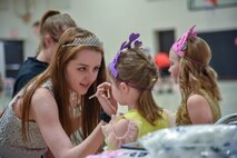 Abbey Johnson, South Dakota National Guard Youth Council member, does the make-up of a child attending the Princess and Super Hero Day Camp April 7, 2018, at the National Guard Armory, Sioux Falls, S.D.