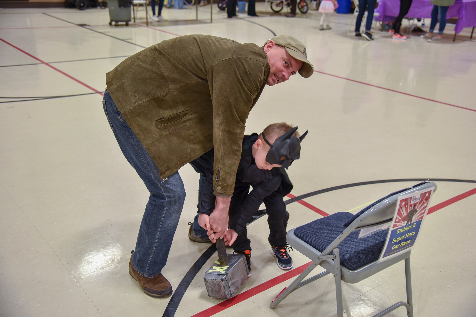 Senior Master Sgt. Dave Adams, 114th Communication Squadron communication plans and resources, and his son attempts to pull Thor’s hammer during the Princess and Super Hero Day Camp April 7, 2018, at the National Guard Armory, Sioux Falls, S.D.