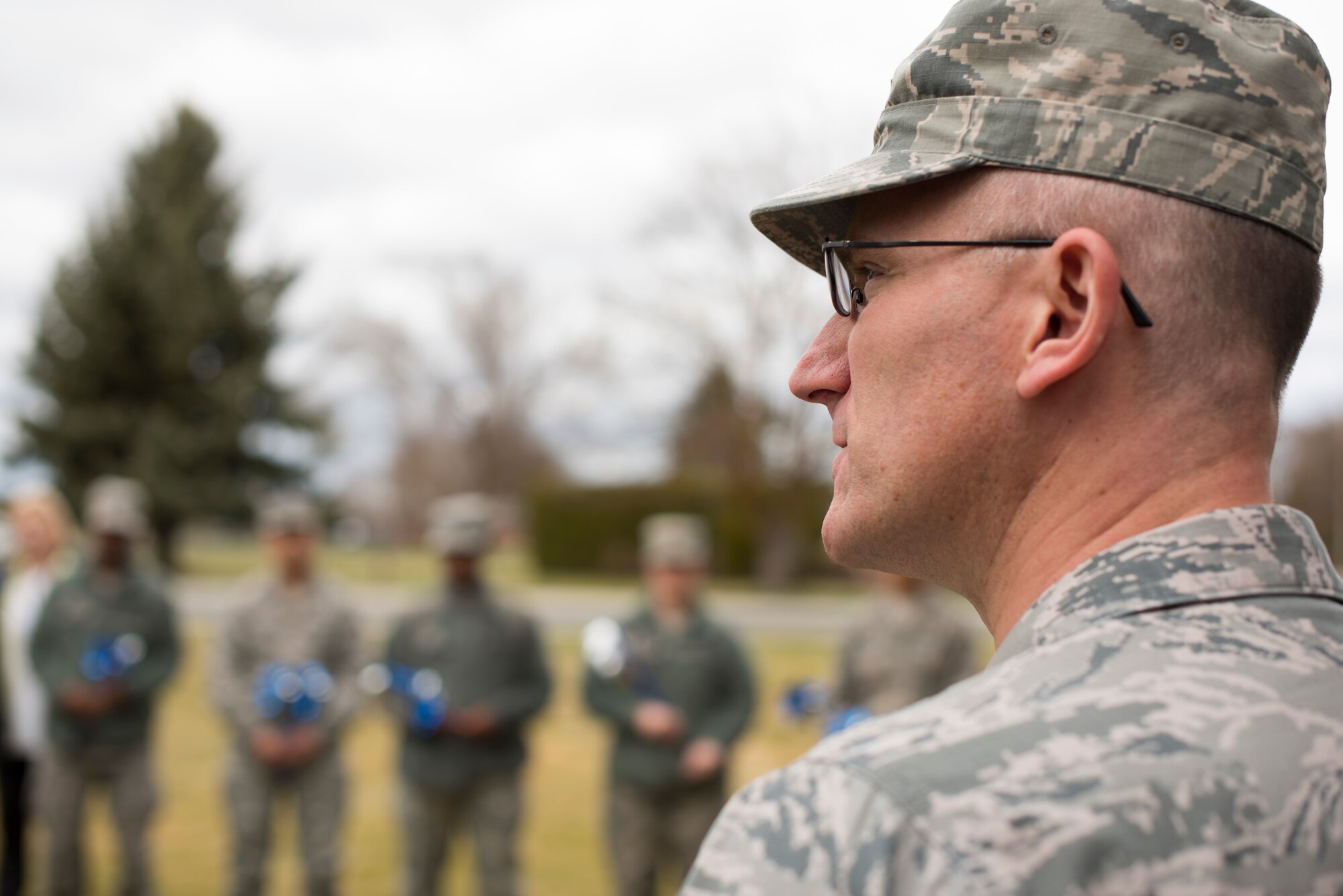 Col. Ryan Samuelson, 92nd Air Refueling Wing commander, speaks to Airmen during a base pinwheel ceremony in honor of Child Abuse Awareness Month at Fairchild Air Force Base, Washington, April 9, 2018. Airmen installed pinwheels at the base chapel to honor Child Abuse Awareness Month. (U.S. Air Force photo/Senior Airman Ryan Lackey)