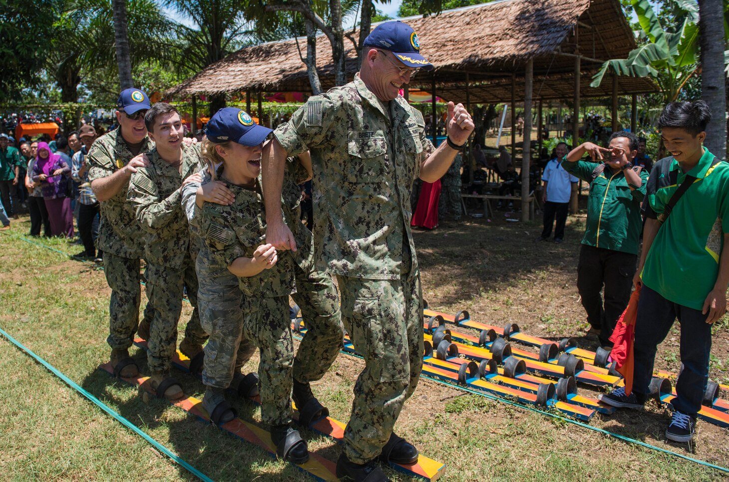 BENGKULU, Indonesia (March 31, 2018) Capt. David Bretz, Mission Commander of Pacific Partnership 2018 (PP18), leads Pacific Partnership 2018 team members in a relay race during a cultural exchange event at Teaching Farm University Dehasen near Bengkulu, Indonesia during Pacific Partnership 2018 (PP18). PP18’s mission is to work collectively with host and partner nations to enhance regional interoperability and disaster response capabilities, increased stability and security in the region, and foster new and enduring friendships across the Indo-Pacific Region. Pacific Partnership, now in its 13th iteration, is the largest annual multinational humanitarian assistance and disaster relief preparedness mission conducted in the Indo-Pacific. (U.S. Navy photo by Mass Communication Specialist 2nd Class Joshua Fulton/Released)