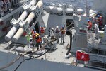 USNS WASHINGTON CHAMBERS, At Sea— Safety observers from Military Sealift Command’s dry cargo and ammunition ship USNS Washington Chambers (T-AKE 11) monitor and relay real-time communication of each step of the underway replenishment (UNREP) process aboard Royal Malaysian Navy frigate KD Lekiu (F30) during an UNREP, April 7.