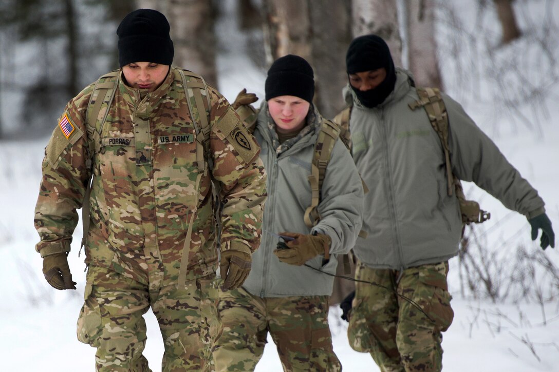 A soldier leads members of his unit during land navigation training.