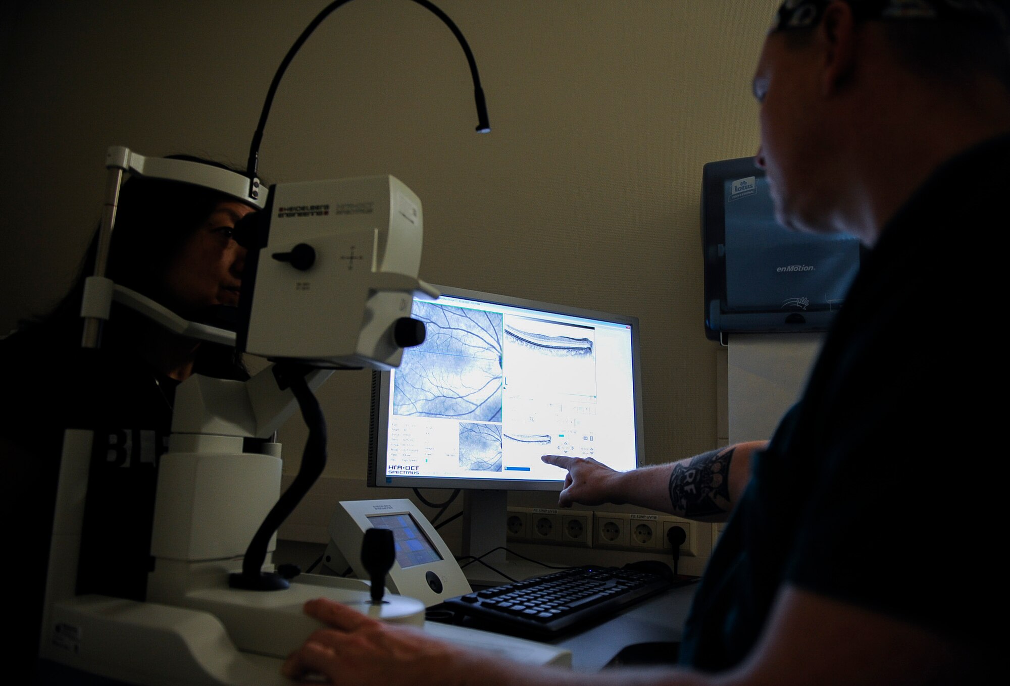 U.S. Air Force Tech. Sgt. Michael Mayes, 86th Medical Squadron ophthalmology clinic noncommissioned officer in charge, inspects a patient’s eye at Landstuhl Regional Medical Center, Germany, Nov. 16, 2017. The clinic offers ophthalmology eye disease management and eye surgeries to military members, dependents, retirees and qualified Department of Defense civilians. (U.S. Air Force photo by Senior Airman Savannah L. Waters)