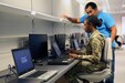 Soldier and Civilian at computer