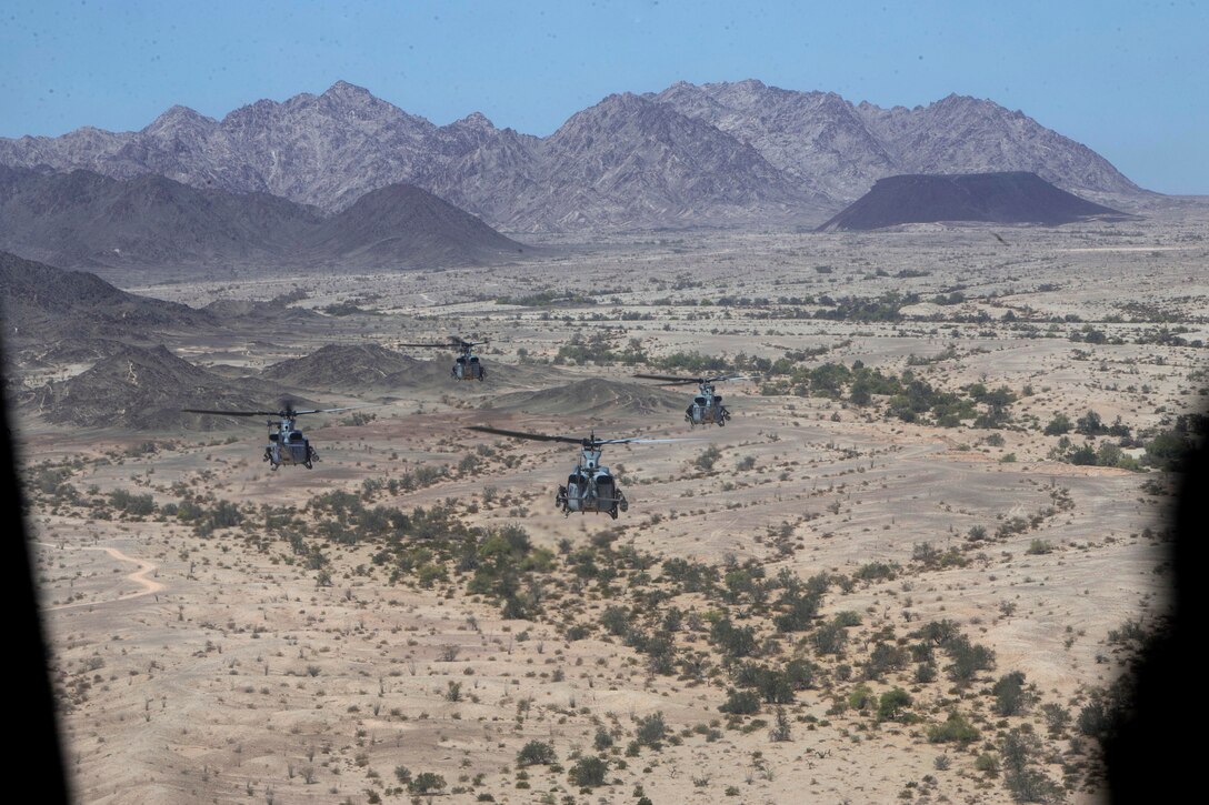 Four Marine Corps UH-1Y Venom helicopters fly in formation.