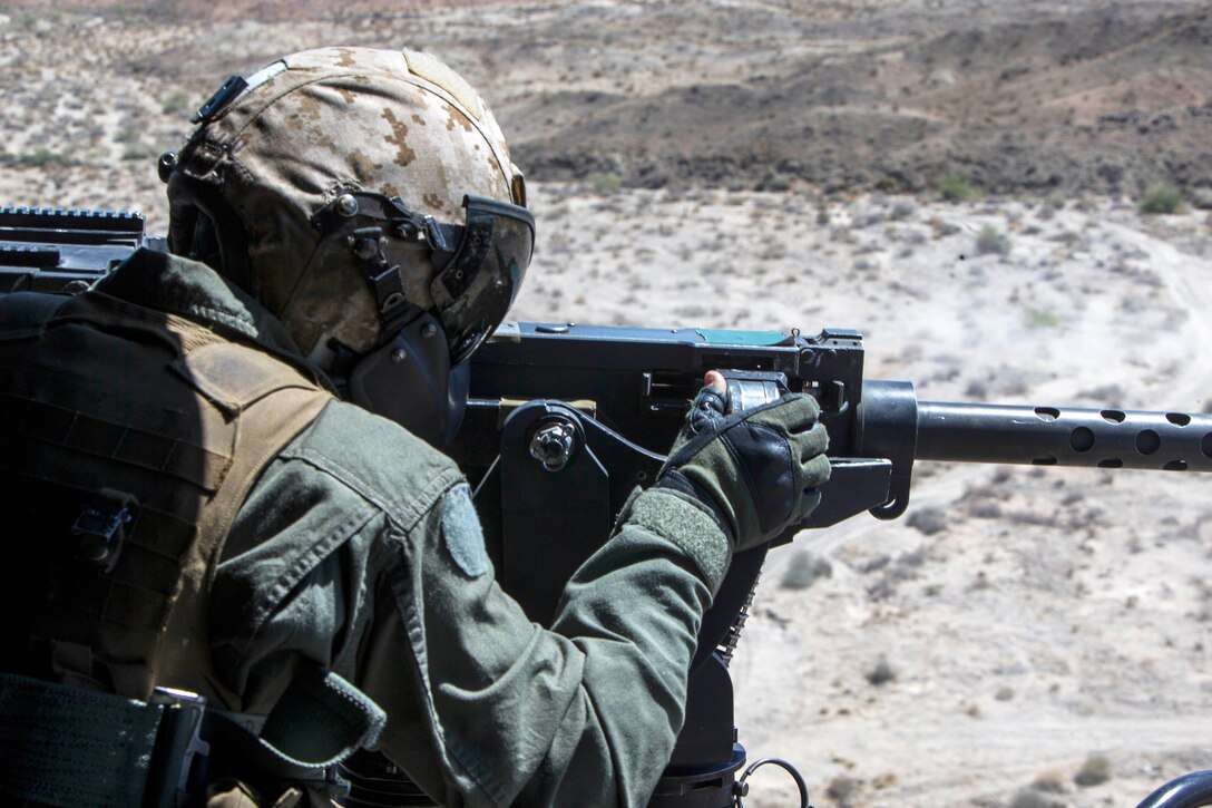 A Marine operates a .50-caliber machine gun.