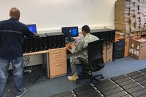 Soldier and civilian at computers