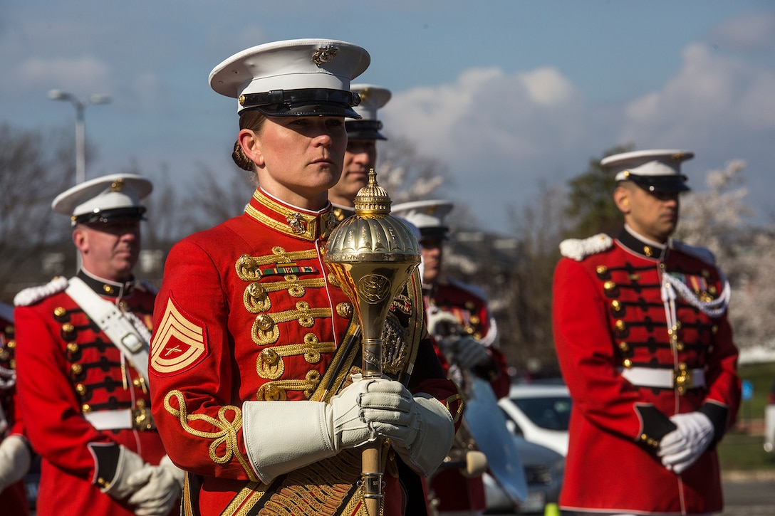 Gunnery Sgt. Stacie Crowther, assistant drum major, “The President’s Own” U.S. Marine Band, stands at a ceremonial position during a full honors funeral for Maj. Gen. John A. Studds at Arlington National Cemetery, Arlington, Virginia, April 10, 2018. General Studds was commissioned into the Marine Corps in 1960 and served the following 33 years as an Infantry Officer. He commanded Marines at all levels including; Commander, Charlie Company, 3rd Reconnaissance Battalion in Vietnam where he received the Bronze Star with Combat "V" for valor and was the Director of Marine Corps Intelligence during Operations Desert Shield and Desert Storm. Studds concluded his devout career as the Commanding General, Marine Corps Recruit Depot, San Diego. (Official U.S. Marine Corps photo by Sgt. Robert Knapp/Released)