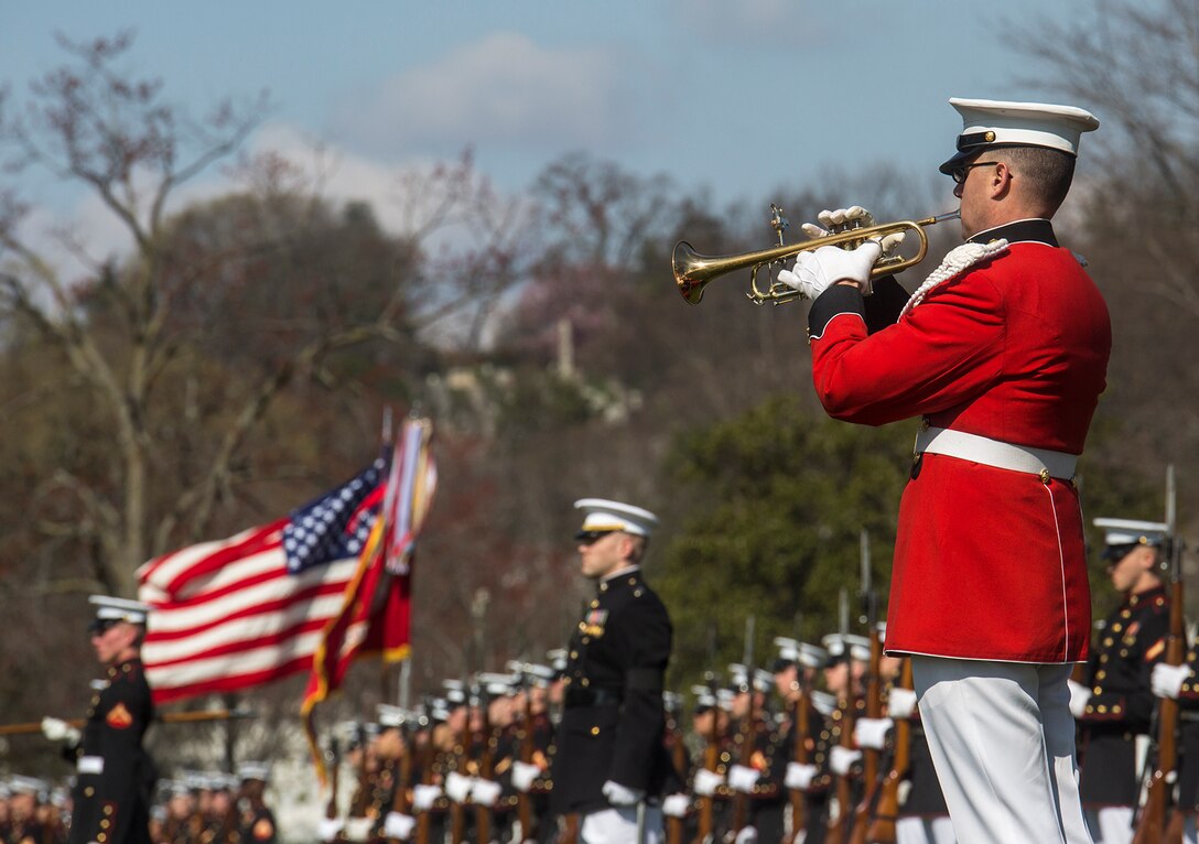 A Marine with “The President’s Own” U.S. Marine Band plays Taps during a full honors funeral for Maj. Gen. John A. Studds at Arlington National Cemetery, Arlington, Virginia, April 10, 2018. General Studds was commissioned into the Marine Corps in 1960 and served the following 33 years as an Infantry Officer. He commanded Marines at all levels including; Commander, Charlie Company, 3rd Reconnaissance Battalion in Vietnam where he received the Bronze Star with Combat "V" for valor and was the Director of Marine Corps Intelligence during Operations Desert Shield and Desert Storm. Studds concluded his devout career as the Commanding General, Marine Corps Recruit Depot, San Diego. (Official U.S. Marine Corps photo by Sgt. Robert Knapp/Released)