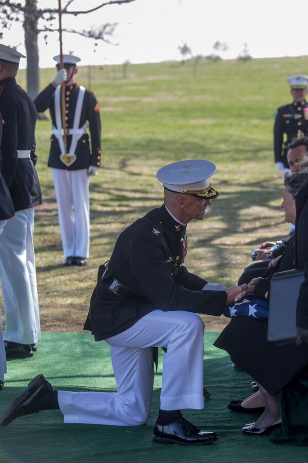 Colonel Tyler J. Zagurski, commanding officer, Marine Barracks Washington D.C., presents the National Flag to the next of kin during a full honors funeral for Maj. Gen. John A. Studds at Arlington National Cemetery, Arlington, Va, April 10, 2018. General Studds was commissioned into the Marine Corps in 1960 and served the following 33 years as an Infantry Officer. He commanded Marines at all levels including; Commander, Charlie Company, 3rd Reconnaissance Battalion in Vietnam where he received the Bronze Star with Combat "V" for valor and was the Director of Marine Corps Intelligence during Operations Desert Shield and Desert Storm. Studds concluded his devout career as the Commanding General, Marine Corps Recruit Depot, San Diego. (Official U.S. Marine Corps photo by Sgt. Robert Knapp/Released)