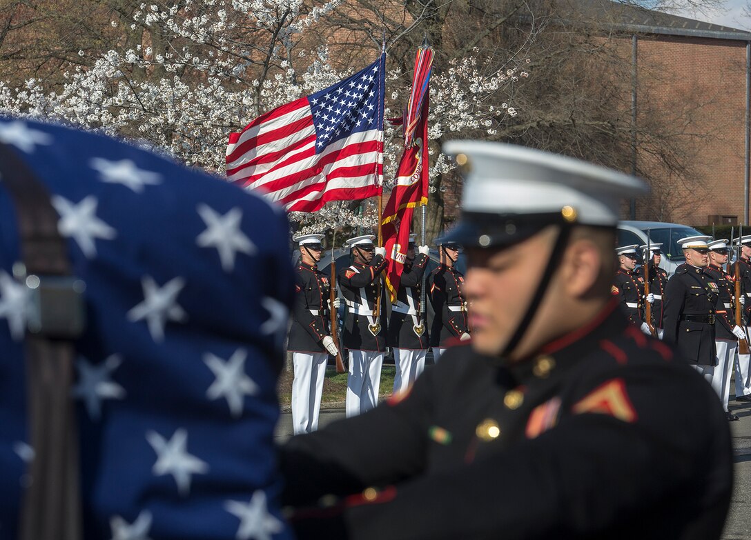 The U.S. Marine Corps Color Guard presents the National Flag and Marine Corps Battle Colors during a full honors funeral for Maj. Gen. John A. Studds at Arlington National Cemetery, Arlington, Virginia, April 10, 2018. General Studds was commissioned into the Marine Corps in 1960 and served the following 33 years as an Infantry Officer. He commanded Marines at all levels including; Commander, Charlie Company, 3rd Reconnaissance Battalion in Vietnam where he received the Bronze Star with Combat "V" for valor and was the Director of Marine Corps Intelligence during Operations Desert Shield and Desert Storm. Studds concluded his devout career as the Commanding General, Marine Corps Recruit Depot, San Diego. (Official U.S. Marine Corps photo by Sgt. Robert Knapp/Released)
