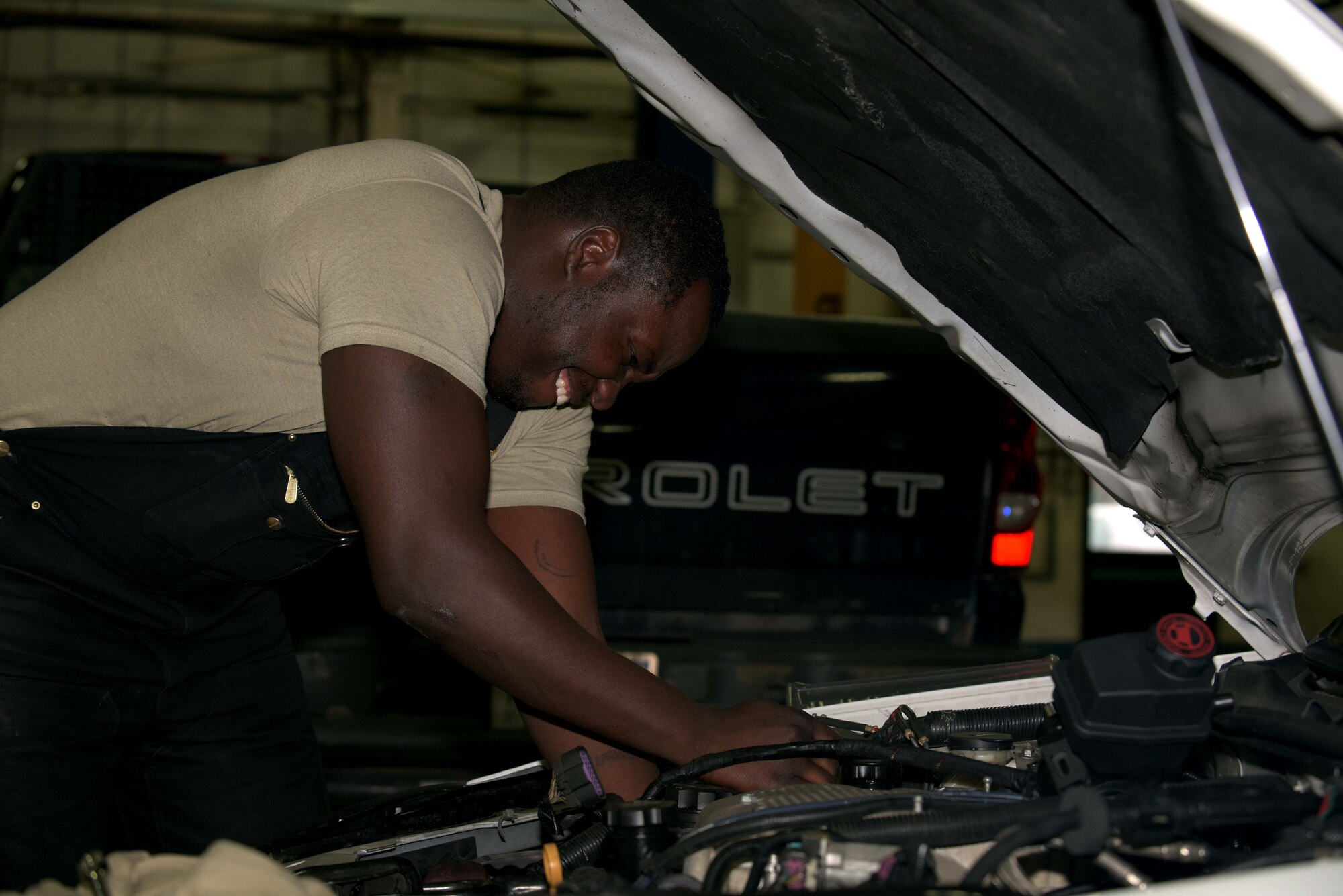 U.S. Air Force Staff Sgt. Markeith Roberson, 100th Logistics Readiness Squadron mission generating general purpose maintenance supervisor, works on an engine of a security forces vehicle at RAF Mildenhall, England, Jan. 29, 2018. Vehicle maintenance handles a wide variety of vehicles such as Humvees, cranes, vans and security forces vehicles. (U.S. Air Force photo by Airman 1st Class Benjamin Cooper)
