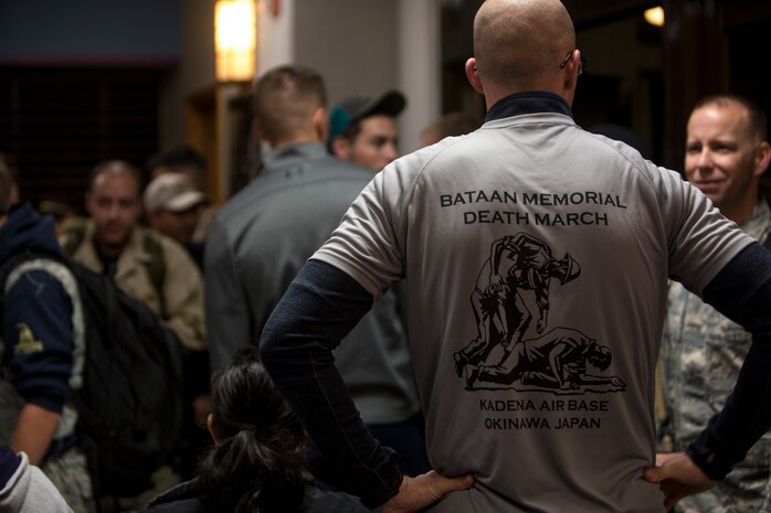 A volunteer gives out commemorative shirts to participants before the Bataan Death March Memorial hike, April 7, 2018 on Kadena Air Force base, Okinawa, Japan. More than 200 service members and their families participated in the 8.5 mile hike around Kadena’s perimeter in remembrance of the prisoners of war who perished as a result of the Death March that took place in the Philippine archipelago in 1942 during WWII.