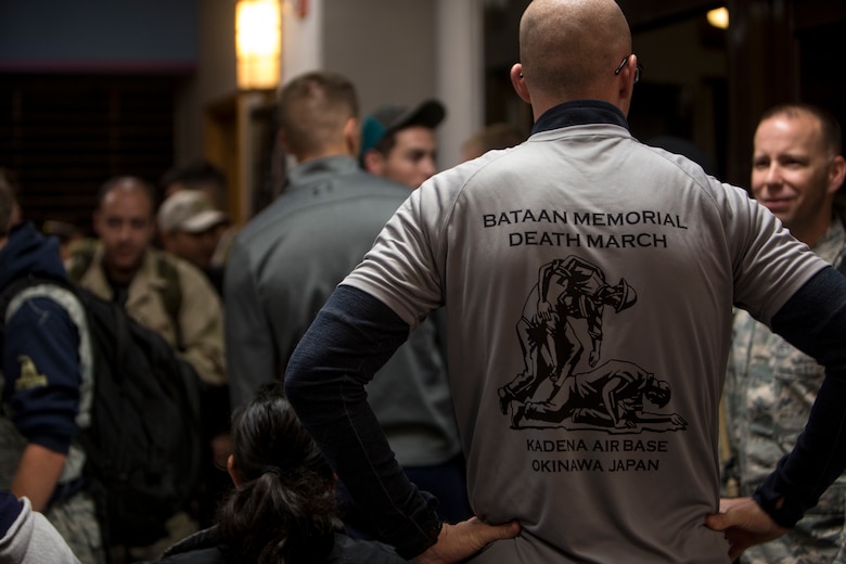 A volunteer gives out commemorative shirts to participants before the Bataan Death March Memorial hike, April 7, 2018 on Kadena Air Force base, Okinawa, Japan. More than 200 service members and their families participated in the 8.5 mile hike around Kadena’s perimeter in remembrance of the prisoners of war who perished as a result of the Death March that took place in the Philippine archipelago in 1942 during WWII.