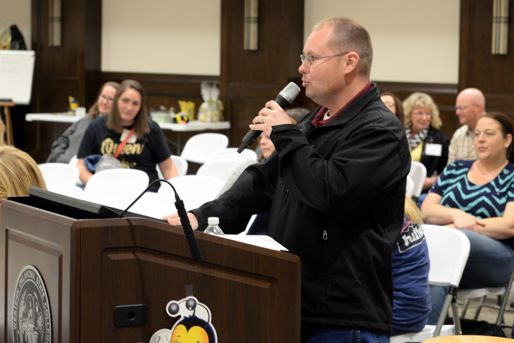 U.S. Air Force Lt. Col. Jeremy Braswell, 97th Medical Support Squadron commander, pronounces words during the “Grate” Altus Spelling Bee, April 7, 2018, at Western Oklahoma State College, Altus, Okla.
