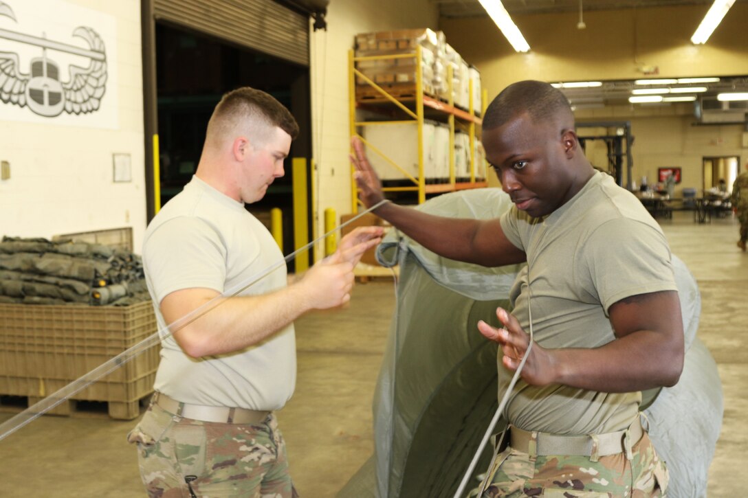 Parachute riggers focused on providing safe landings