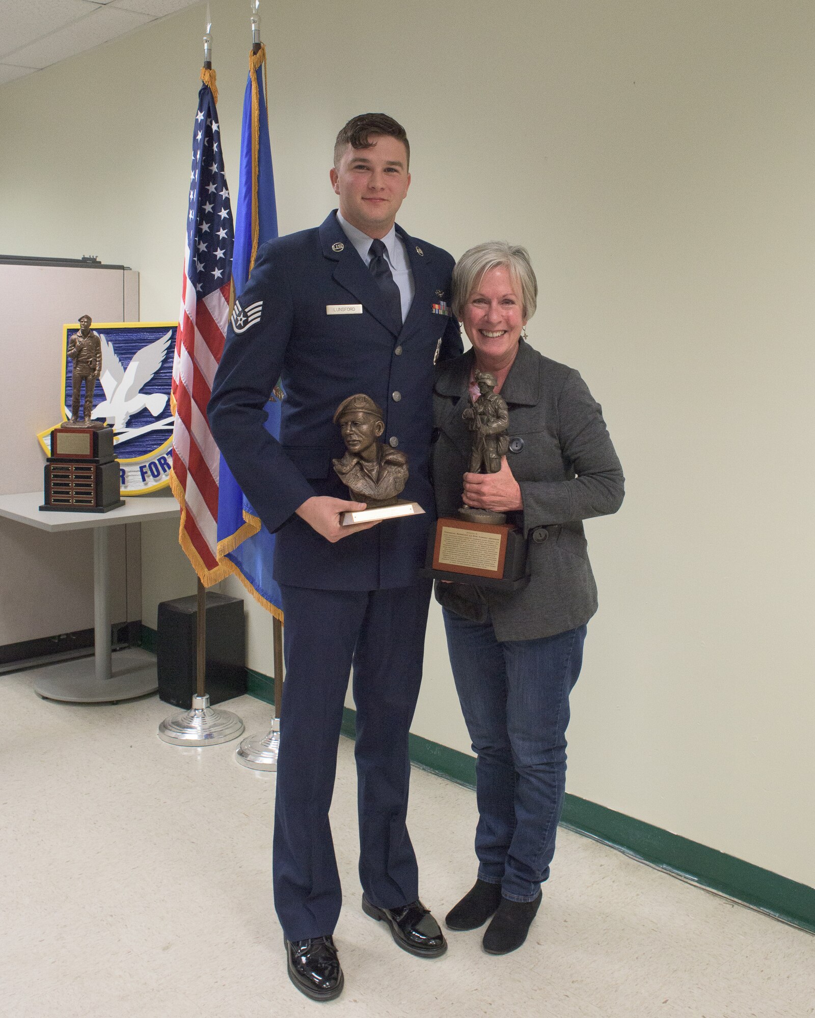 U.S. Air Force Staff Sgt. James Lunsford, 137th Special Operations Security Forces Squadron, poses with Phyllis Johnson, La Don Johnson's widow, after receiving the La Don Johnson Award during the first annual defender of the year award ceremony at Will Rogers Air National Guard Base in Oklahoma City, Feb. 3, 2018. The recipient of the award is chosen by peers of the 137 SOSFS Airmen for continued excellence in everyday duties. (U.S. Air National Guard photo by Tech. Sgt. Caroline Essex)