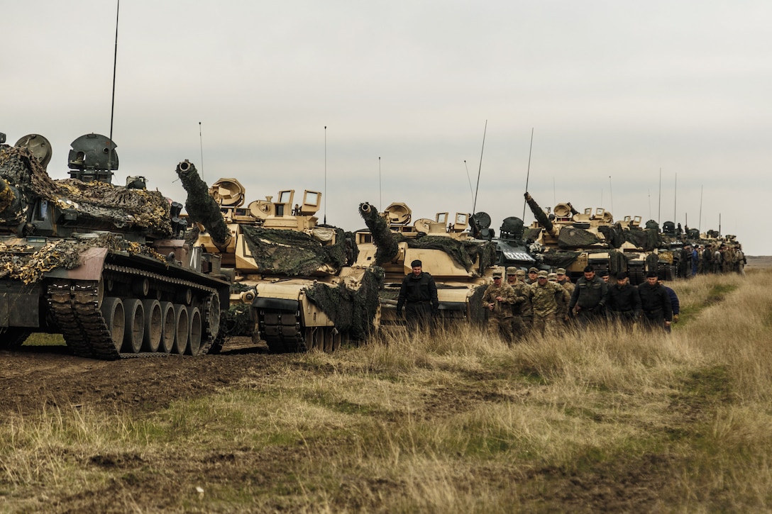 American M1 Abrams and Romanian TR-85 tanks and personnel on training ground in Romania as part of Operation Atlantic Resolve, supporting security and stability in Europe, April 2017 (NATO)
