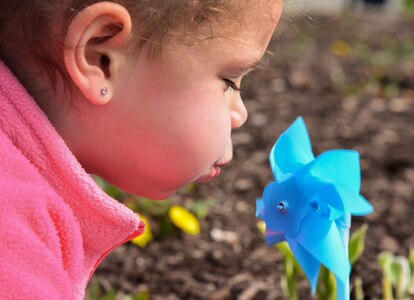 Madison Rauch, age 4, daughter of Kasana Rauch, 480th Intelligence Reconnaissance Readiness squadron contractor, plays with a planted pinwheel at the Russ Child Development Center annex at Joint Base Langley-Eustis, Va., April 2, 2018.