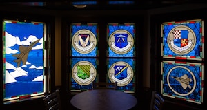 Stained glass windows depict an F-15 Strike Eagle, an F-22 Raptor and the emblems of the five wings at Joint Base Langley-Eustis, Va., at the Nose Dive Lounge on JBLE, April, 10, 2018.