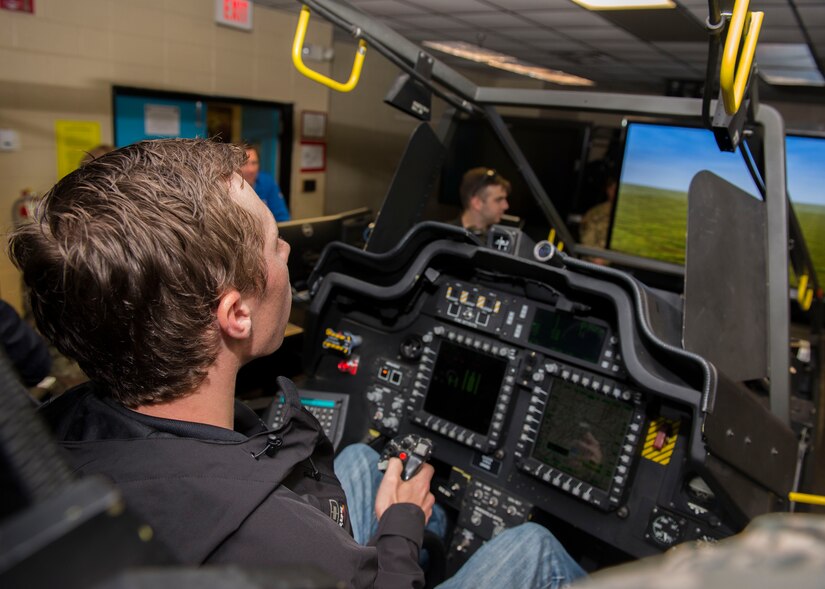 NASCAR driver Brandon Jones tries out the U.S. Army Apache Helicopter Longbow Task Trainer in Fort Eustis’ 128th Aviation Brigade schoolhouse at Joint Base Langley-Eustis, Virginia, April 4, 2018. Jones used the flight simulator to get a better idea of what type of helicopter the Soldiers were learning to repair. (U.S. Air Force photo by Airman 1st Class Monica Roybal)
