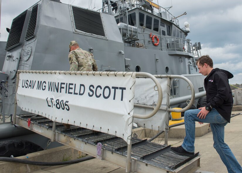 NASCAR driver Brandon Jones steps on board the large tug 805 Major General Winfield Scott in Fort Eustis’ 3rd Port at Joint Base Langley-Eustis, Virginia, April 4, 2018. U.S. Army Chief Warrant Officer 3 Marcus Gandee, 73rd Transportation Company, 10th Transportation Battalion, 7th Transportation Brigade (Expeditionary) 1st engineer, guided Jones throughout the tour to give him an inside look at their duties. (U.S. Air Force photo by Airman 1st Class Monica Roybal)