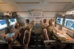 Airmen from 116th Air Control Wing, Georgia Air National Guard, monitor surveillance data while flying night mission aboard E-8C Joint STARS, Robins
Air Force Base, Georgia, July 2017 (U.S. Air National Guard/Roger Parsons/Portions of photo have been blurred for security and privacy concerns)