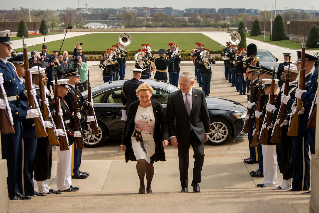Defense Secretary James N. Mattis walks up the steps with the Dutch defense minister.