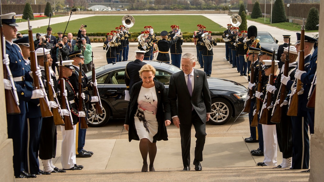 Defense Secretary James N. Mattis walks up the steps with the Dutch defense minister.