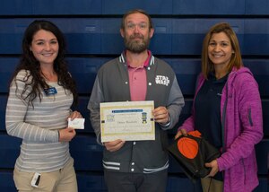 From left, Kellie Jorgensen, 633rd Force Support Squadron fitness center director, Danny Weatherly, Alpha Company, 210th Aviation Regiment, 1st Aviation Battalion, 128th Aviation Brigade aviation maintenance instructor, and Michele Giuseffe, 633rd FSS recreational assistant, display the certificate and prizes awarded to Weatherly as the top male competitor in the “Biggest Loser” challenge at Joint Base Langley-Eustis, Virginia, April 9, 2018. The 12 week-long competition helped participants practice and monitor healthy diet and fitness habits. (U.S. Air Force photo by Airman 1st Class Monica Roybal)