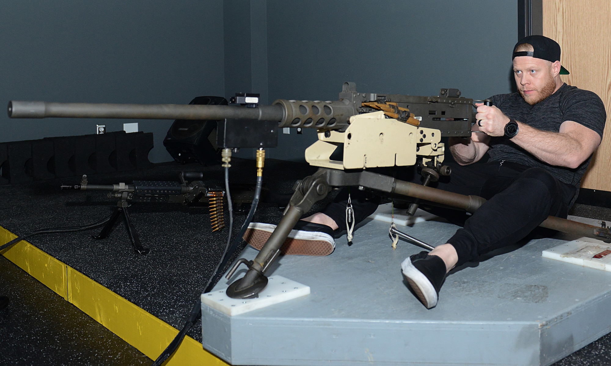Eric Nicksick, Mixed Martial Arts coach and trainer, fires a .50-caliber rifle simulator during a tour at Joint Base Langley-Eustis, Va., April 5, 2018.