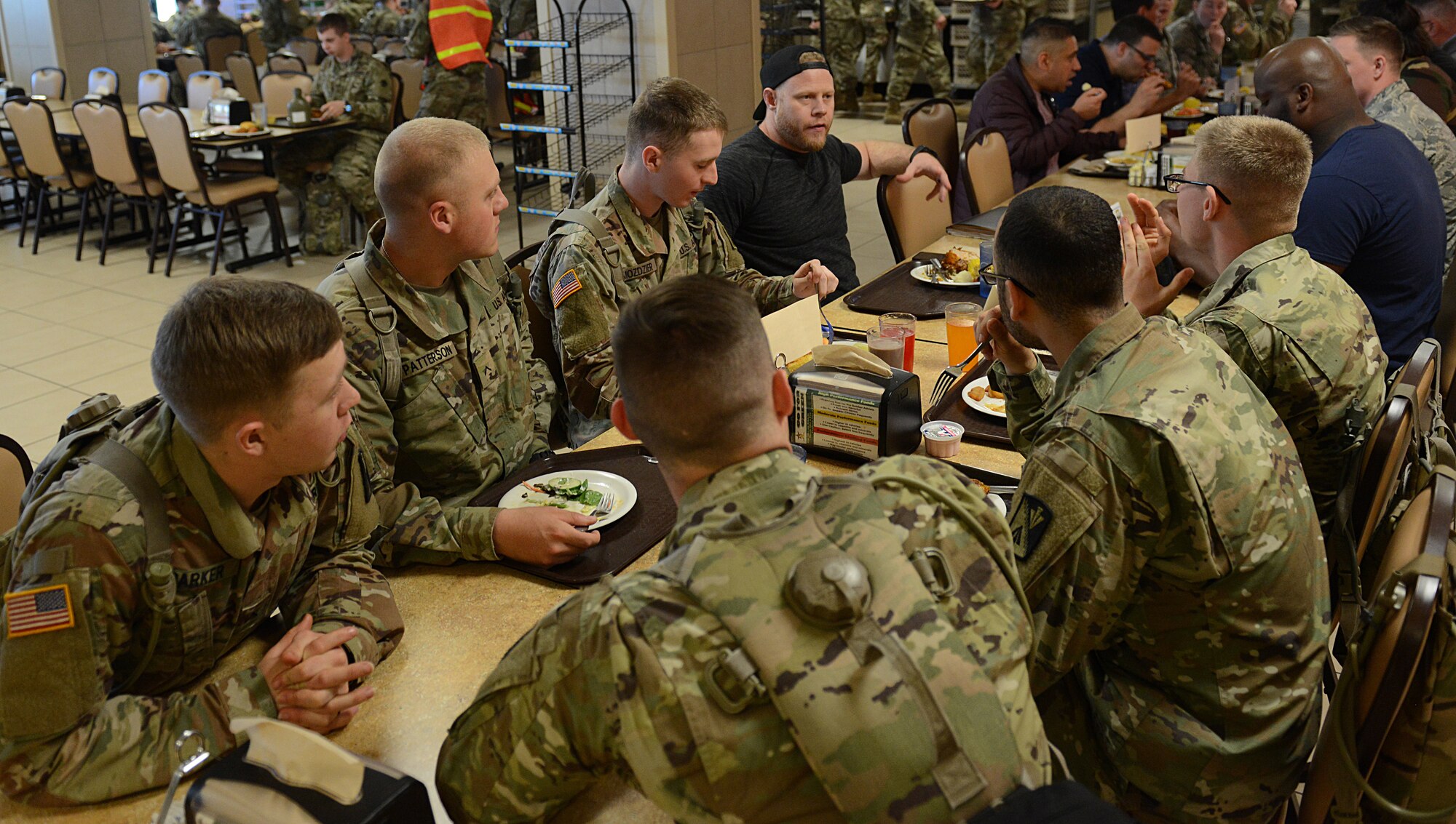 Ultimate Fighting Championship fighters and radio hosts eat lunch with U.S. Army Soldiers from the 128th Aviation Brigade during a visit to Joint Base Langley-Eustis, Va., April 5, 2018.