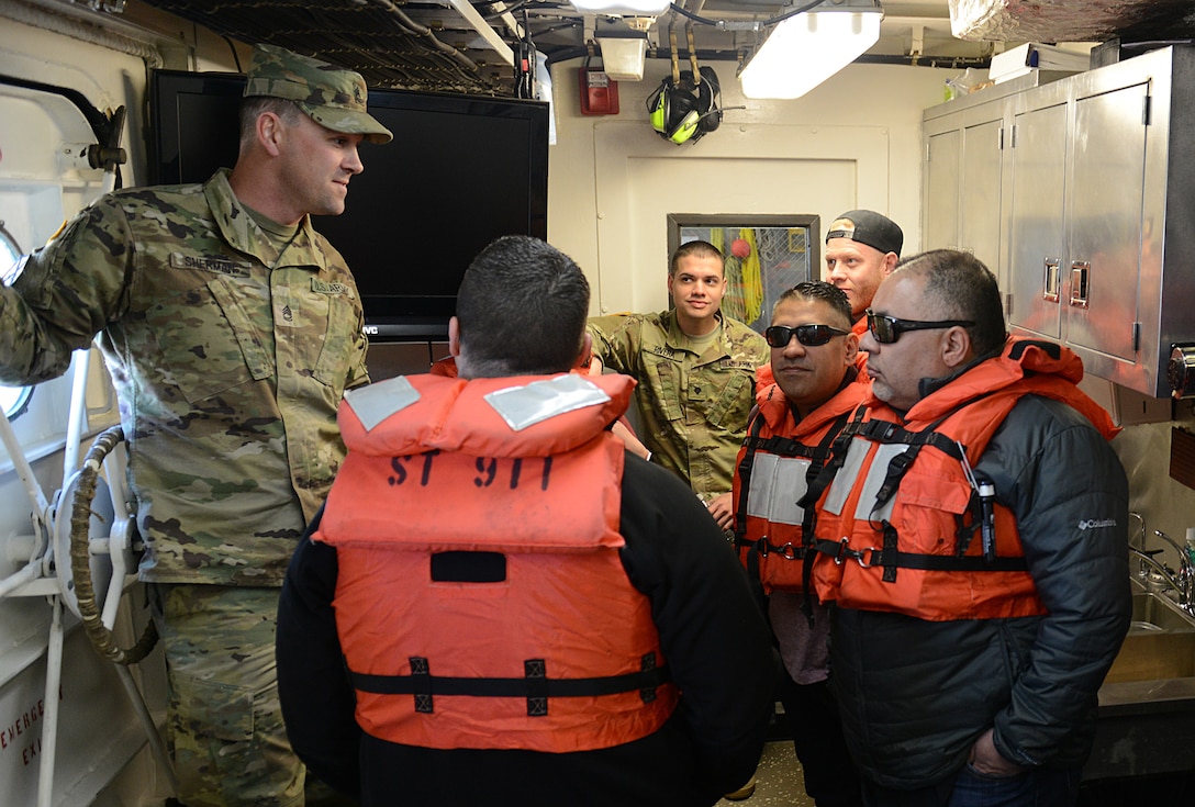 Ultimate Fighting Championship fighters and radio hosts take a tour of a 7th Transportation Brigade (Expeditionary) watercraft vessel during a visit to Joint Base Langley-Eustis, Va., April 5, 2018.