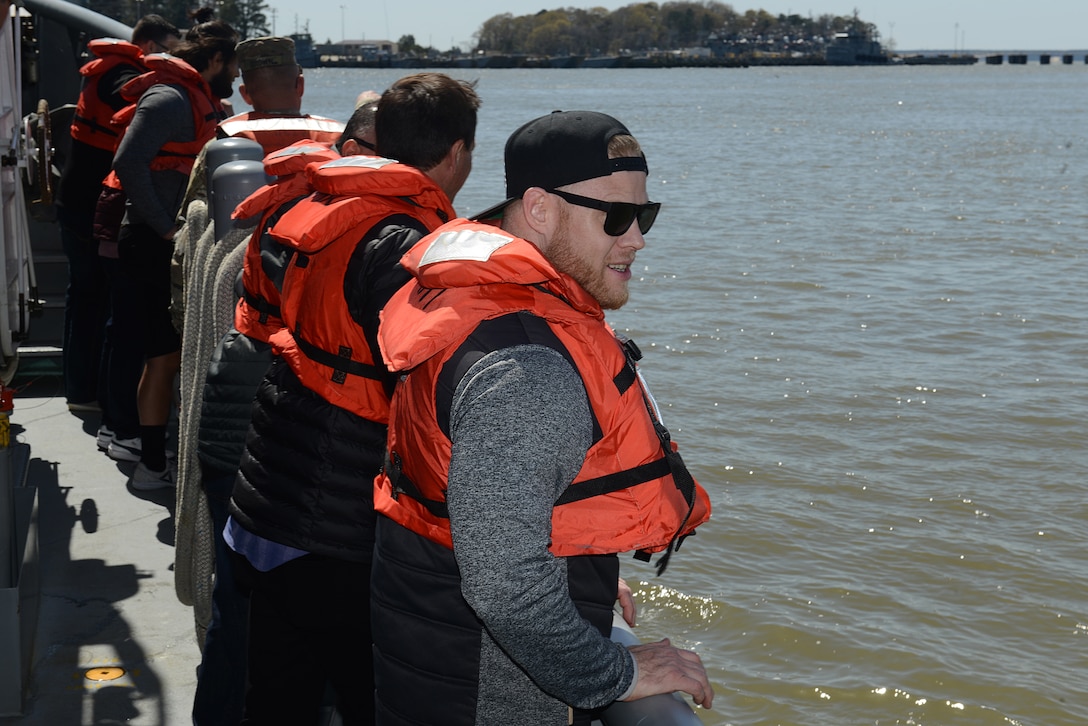 Ultimate Fighting Championship fighters and radio hosts look out on the James River from a 7th Transportation Brigade (Expeditionary) watercraft vessel during a visit to Joint Base Langley-Eustis, Va., April 5, 2018.