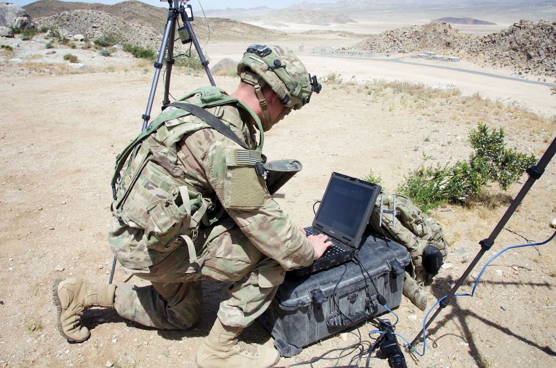Soldier with 780th Military Intelligence Brigade sets up cyber tools overlooking mock city of Razish at National Training Center, Fort Irwin, California, May 5, 2017, as part of Army Cyber Command–led Cyber-Electromagnetic Activities Support to Corps and Below Initiative (U.S. Army Cyber Command/Bill Roche)