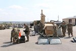 Soldiers unload serviceable equipment onto pallets for turn in to Sierra Army Depot that will be inventoried back into the Global Combat Support System.