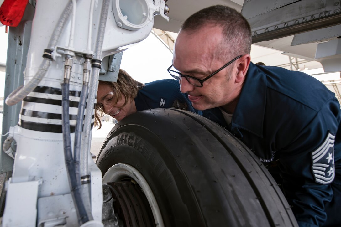 Chief Master Sgt. Jarrod Sebastian, right, 23d Wing command chief, and Col. Jennifer Short, left, 23d WG commander, push a tire into place, April 9, 2018, at Moody Air Force Base, Ga. Moody’s leadership toured the 23d Aircraft Maintenance Squadron to get a better understanding of their overall mission, capabilities, and comprehensive duties. (U.S. Air Force photo by Airman Eugene Oliver)