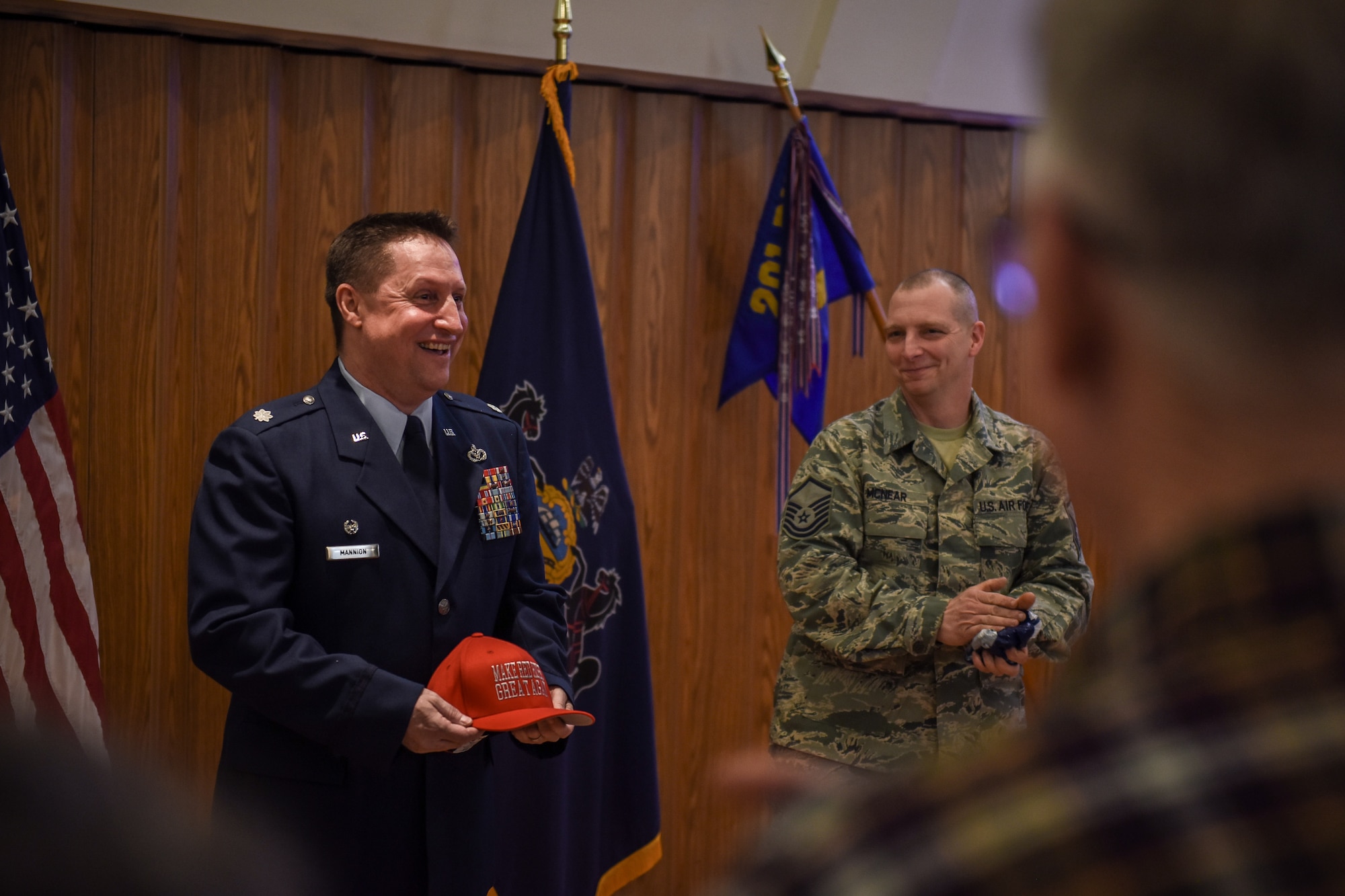 Lt. Col. Eric Mannion reacts to a gift from Airmen during the 201st RED HORSE assumption of command ceremony.