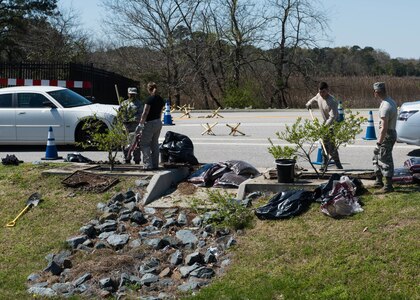 Volunteers perform maintenance on Filterra Stormwater Bioretention Systems at Joint Base langley-Eustis, Va., April 5, 2018.