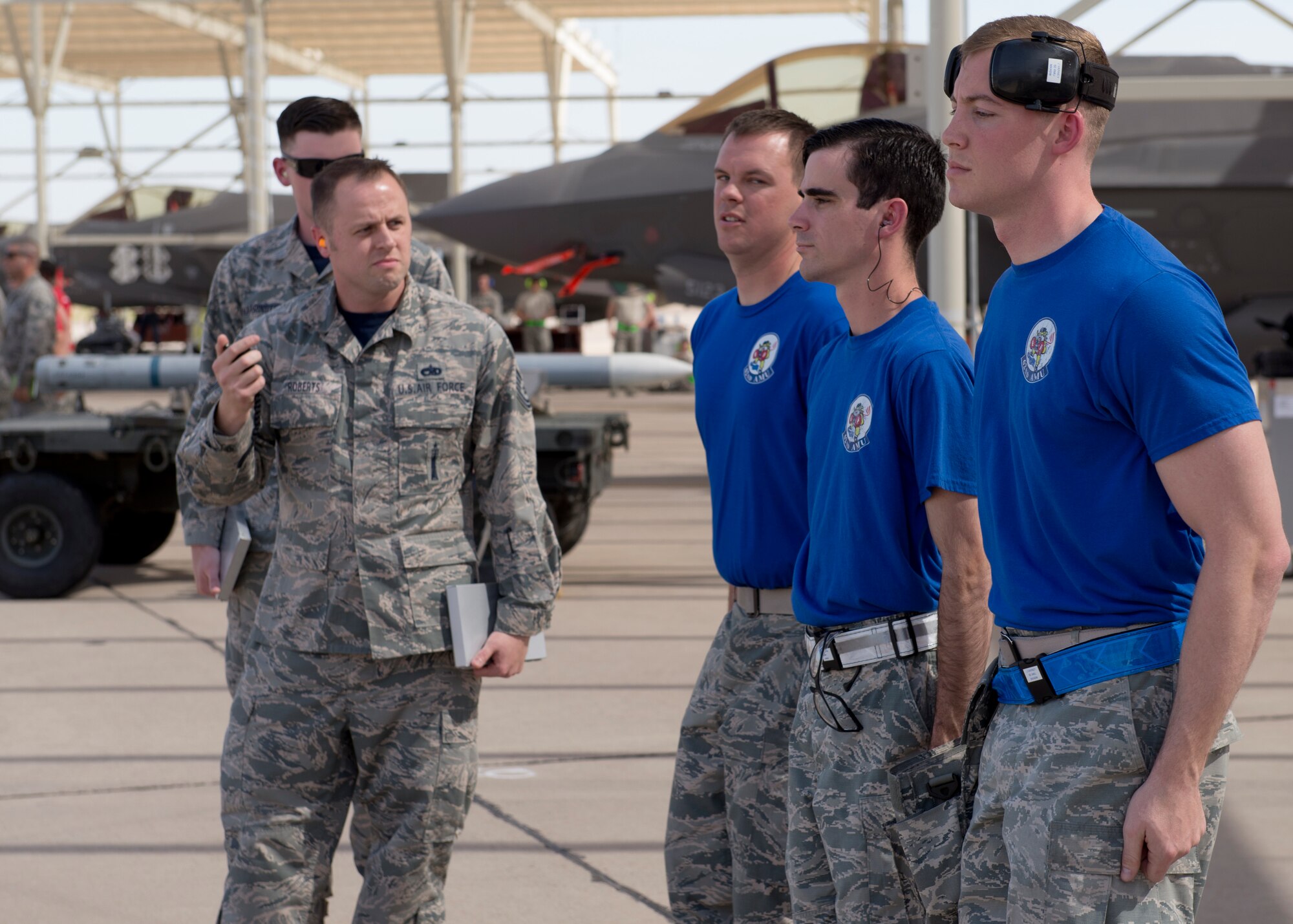 Judges start the timer on a weapons load crew from the 62nd Aircraft Maintenance Unit as they compete in the 2018 1st Quarter Load Crew Competition at Luke Air Force Base, Ariz., April 6. The team competed against others to load weapons onto a fighter aircraft correctly and safely in the fastest time. (U.S. Air Force photo by Senior Airman Ridge Shan)